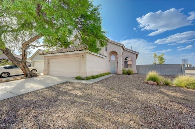 7528 Golden Yucca Dr, Las Vegas, NV 89147 - mediterranean / spanish-style home featuring concrete driveway, an attached garage, stucco siding, and a tiled roof