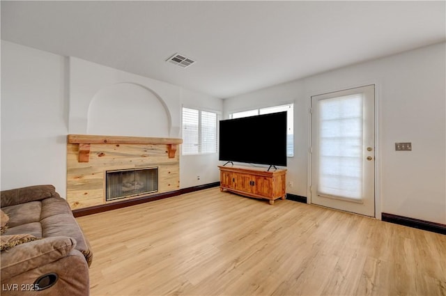 7528 Golden Yucca Dr, Las Vegas, NV 89147 - living area with light wood-style flooring and a fireplace