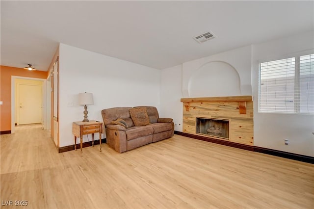 7528 Golden Yucca Dr, Las Vegas, NV 89147 - living room with light wood-type flooring and a tiled fireplace