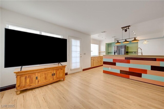 7528 Golden Yucca Dr, Las Vegas, NV 89147 - unfurnished living room featuring light wood-type flooring and a sink