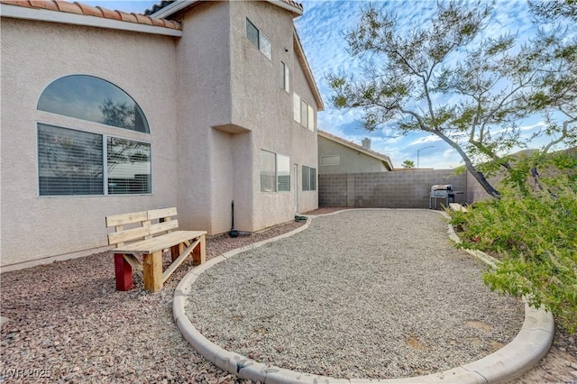 7528 Golden Yucca Dr, Las Vegas, NV 89147 - view of side of home with stucco siding, a fenced backyard, and a tiled roof
