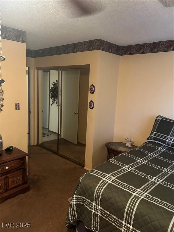 712 Donner St, Las Vegas, NV 89107 - carpeted bedroom featuring a closet, a textured ceiling, and a ceiling fan
