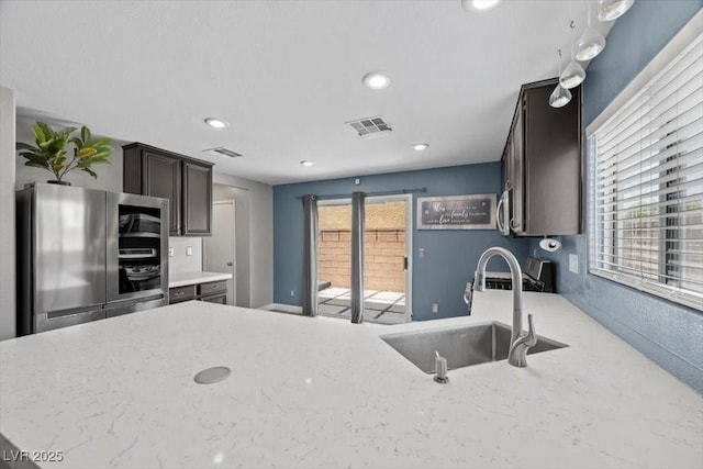 106 Basketflower Ct, Las Vegas, NV 89183 - kitchen with smart refrigerator, a sink, recessed lighting, and light stone countertops