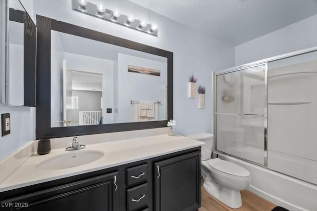 106 Basketflower Ct, Las Vegas, NV 89183 - bathroom featuring vanity, toilet, bath / shower combo with glass door, and wood finished floors