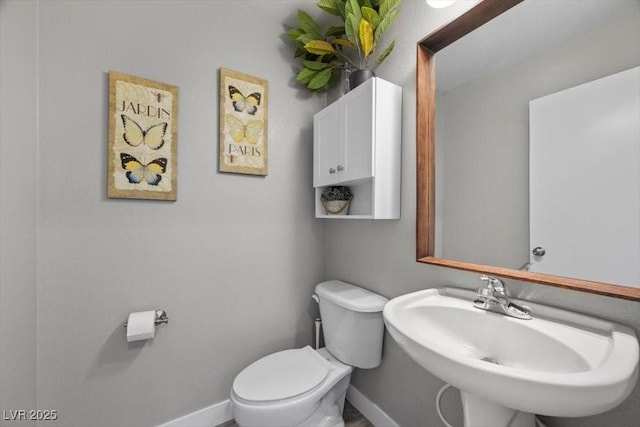 106 Basketflower Ct, Las Vegas, NV 89183 - half bath featuring toilet, baseboards, and a sink