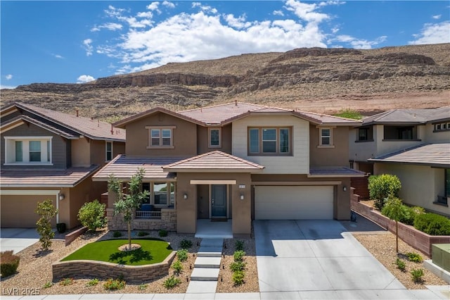 5619 Shadow Bend Dr, Las Vegas, NV 89135 - view of front of house featuring an attached garage, concrete driveway, stucco siding, and a mountain view