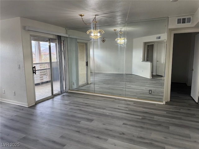 4555 E Sahara Ave Unit 288, Las Vegas, NV 89104 - unfurnished room featuring wood finished floors, baseboards, and a chandelier