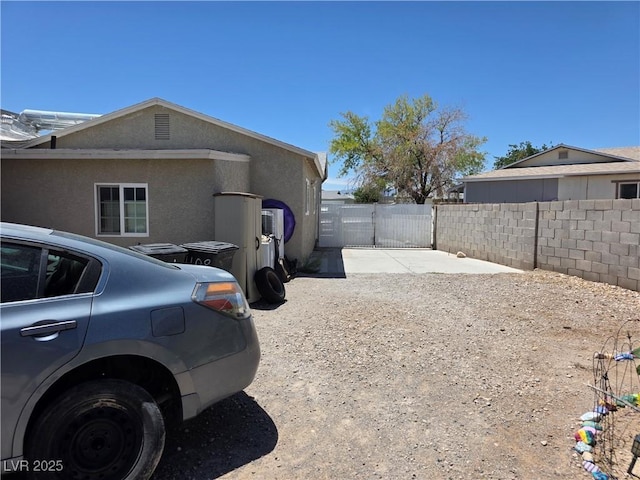 7108 Moon Ct, Las Vegas, NV 89145 - view of property exterior with a gate and stucco siding