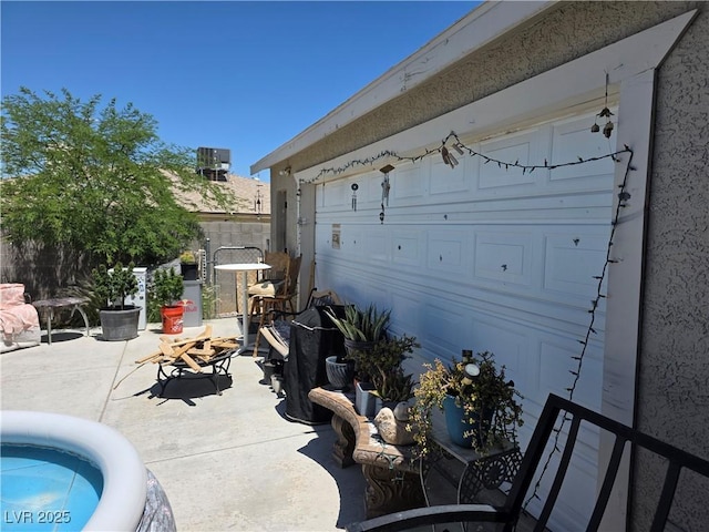 7108 Moon Ct, Las Vegas, NV 89145 - view of patio / terrace with a garage and cooling unit