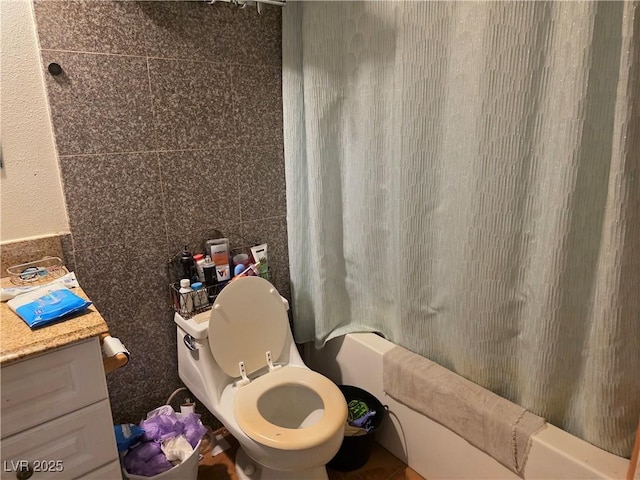 7108 Moon Ct, Las Vegas, NV 89145 - full bathroom featuring shower / bath combination with curtain, toilet, and tile walls