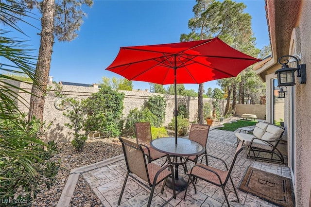 1609 Hidden Spring Dr, Las Vegas, NV 89117 - fenced backyard featuring a patio and outdoor dining space