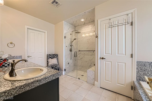 1609 Hidden Spring Dr, Las Vegas, NV 89117 - bathroom with a marble finish shower, vanity, a bathtub, and baseboards