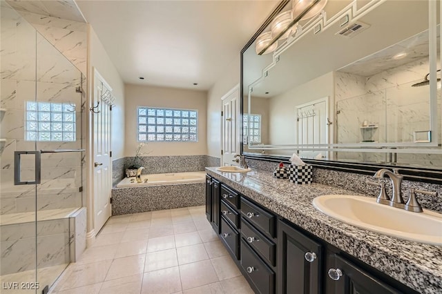 1609 Hidden Spring Dr, Las Vegas, NV 89117 - bathroom featuring a bath, double vanity, a marble finish shower, and tile patterned floors