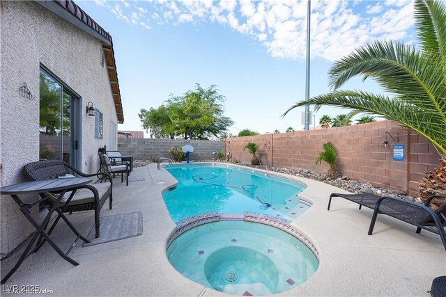 3913 Lilac Haze St, Las Vegas, NV 89147 - view of pool featuring a fenced backyard, a pool with connected hot tub, and a patio area