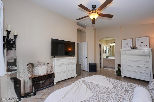 3913 Lilac Haze St, Las Vegas, NV 89147 - tiled bedroom with arched walkways, connected bathroom, and a ceiling fan