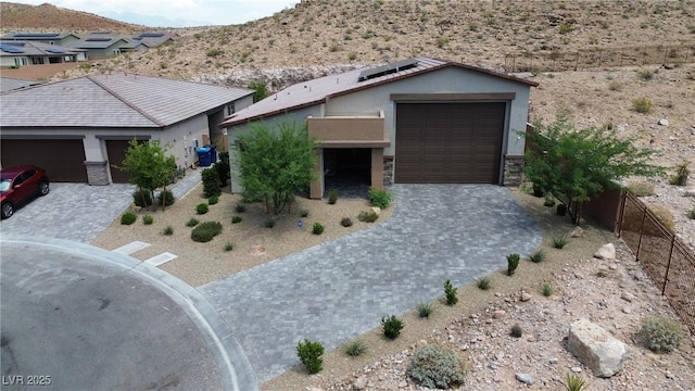 9570 Thistle Creek Ave, Las Vegas, NV 89178 - single story home with solar panels, stucco siding, and a mountain view