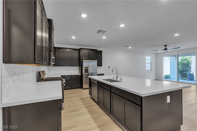 9570 Thistle Creek Ave, Las Vegas, NV 89178 - kitchen with a sink, appliances with stainless steel finishes, backsplash, recessed lighting, and light countertops