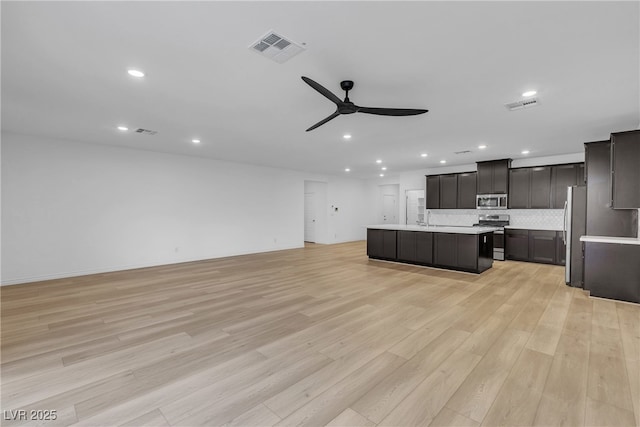 9570 Thistle Creek Ave, Las Vegas, NV 89178 - unfurnished living room with a ceiling fan, light wood-type flooring, recessed lighting, and a sink