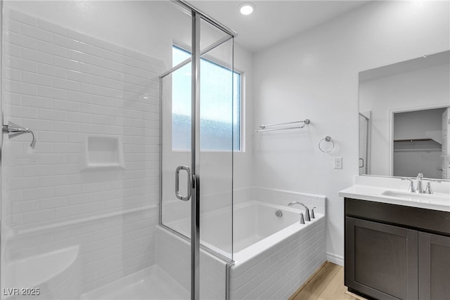 9570 Thistle Creek Ave, Las Vegas, NV 89178 - bathroom with a shower stall, a bath, vanity, and wood finished floors