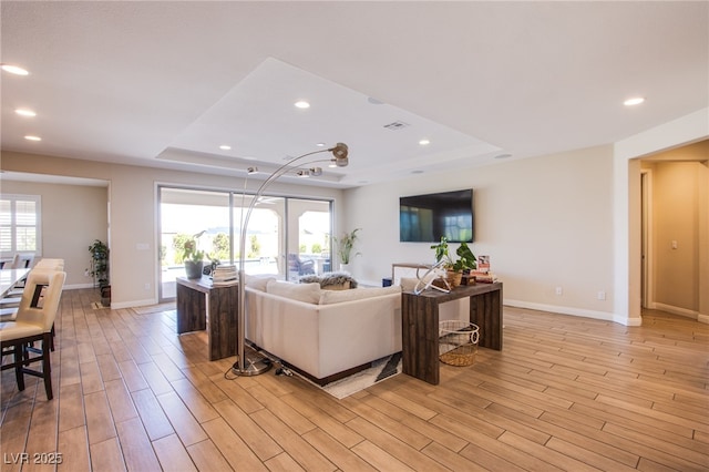 8298 W Agate Ave, Las Vegas, NV 89113 - living area with a tray ceiling, light wood-style flooring, and recessed lighting