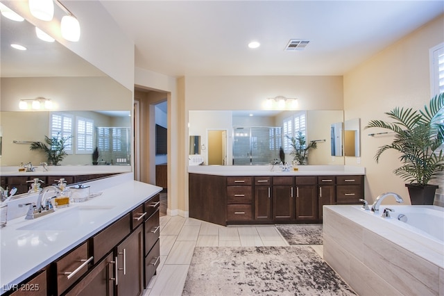 8298 W Agate Ave, Las Vegas, NV 89113 - full bathroom with two vanities, a shower stall, a garden tub, and recessed lighting