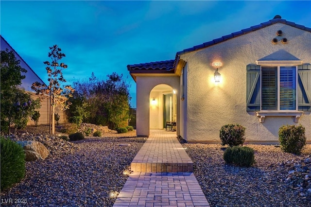8298 W Agate Ave, Las Vegas, NV 89113 - doorway to property featuring stucco siding and a tile roof
