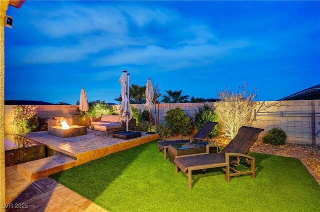 8298 W Agate Ave, Las Vegas, NV 89113 - fenced backyard with a fire pit and a patio