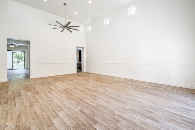 5396 Splendido Ave, Pahrump, NV 89061 - spare room featuring a ceiling fan, light wood-type flooring, recessed lighting, baseboards, and a high ceiling
