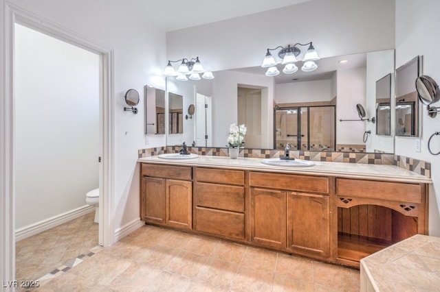 5396 Splendido Ave, Pahrump, NV 89061 - bathroom featuring double vanity, toilet, a shower stall, and baseboards