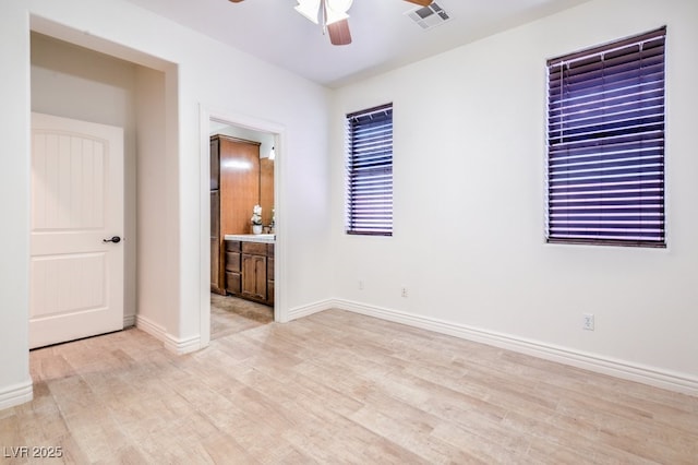 5396 Splendido Ave, Pahrump, NV 89061 - unfurnished bedroom featuring light wood-type flooring, baseboards, connected bathroom, and ceiling fan