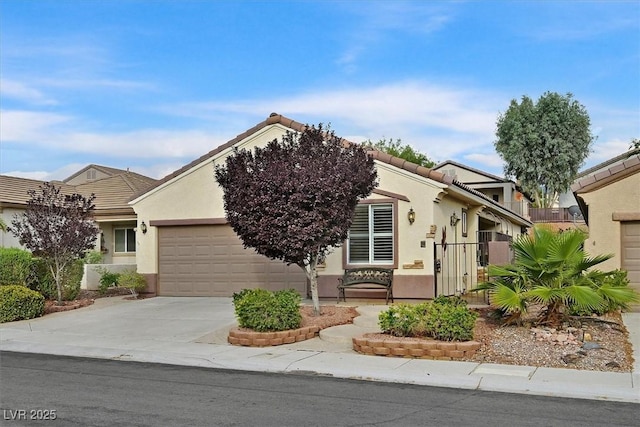 2328 Fossil Canyon Dr, Henderson, NV 89052 - obstructed view of property with driveway, stucco siding, an attached garage, and a tile roof