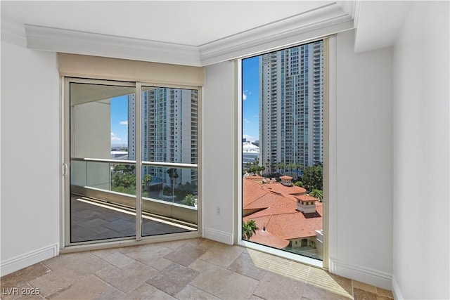 2777 Paradise Rd Unit 1002, Las Vegas, NV 89109 - spare room featuring plenty of natural light, baseboards, stone tile floors, and ornamental molding