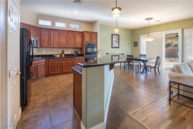9077 Creed Mountain Pl, Las Vegas, NV 89178 - kitchen featuring black appliances, dark countertops, plenty of natural light, and pendant lighting
