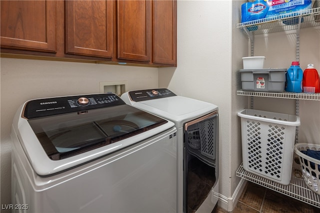 9077 Creed Mountain Pl, Las Vegas, NV 89178 - washroom featuring separate washer and dryer, dark tile patterned floors, and cabinet space
