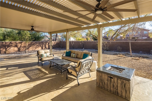 9077 Creed Mountain Pl, Las Vegas, NV 89178 - fenced backyard with ceiling fan, a patio area, and an outdoor living space with a fire pit