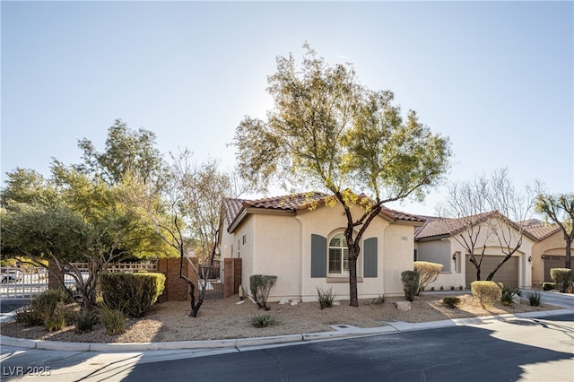 9077 Creed Mountain Pl, Las Vegas, NV 89178 - mediterranean / spanish-style house featuring stucco siding, a tile roof, an attached garage, and driveway