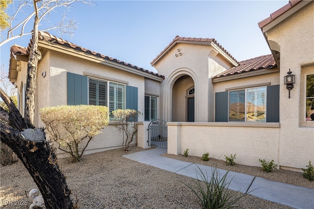 9077 Creed Mountain Pl, Las Vegas, NV 89178 - mediterranean / spanish house featuring a fenced front yard, a gate, stucco siding, and a tile roof