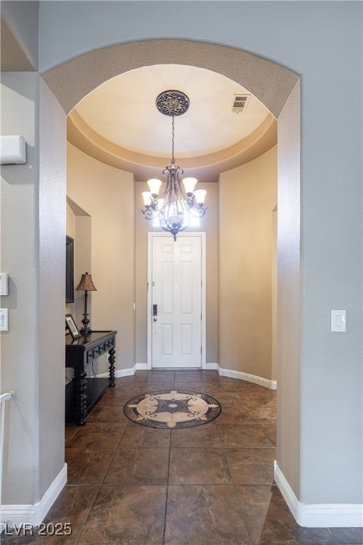 9077 Creed Mountain Pl, Las Vegas, NV 89178 - entrance foyer featuring a chandelier, arched walkways, baseboards, and a tray ceiling