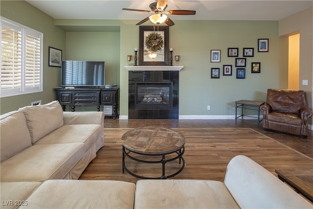 9077 Creed Mountain Pl, Las Vegas, NV 89178 - living area with a fireplace, ceiling fan, wood finished floors, and baseboards