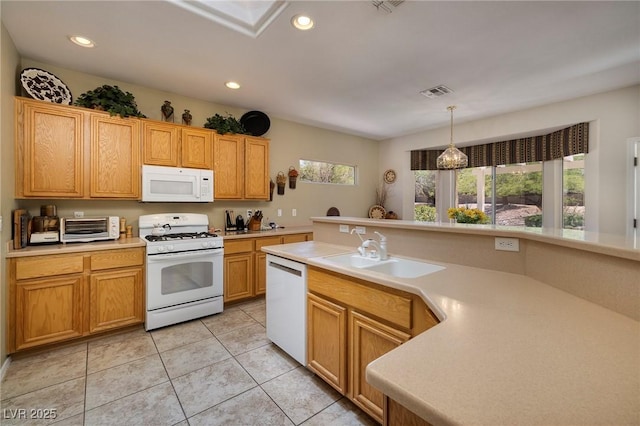 1620 Fieldbrook St, Henderson, NV 89052 - kitchen with white appliances, light countertops, light tile patterned floors, recessed lighting, and pendant lighting