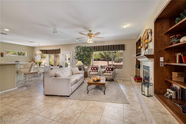 1620 Fieldbrook St, Henderson, NV 89052 - living area with ceiling fan, a glass covered fireplace, light tile patterned flooring, and recessed lighting