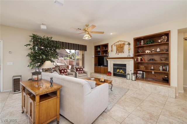 1620 Fieldbrook St, Henderson, NV 89052 - living area with a ceiling fan, light tile patterned floors, a tile fireplace, built in features, and beverage cooler