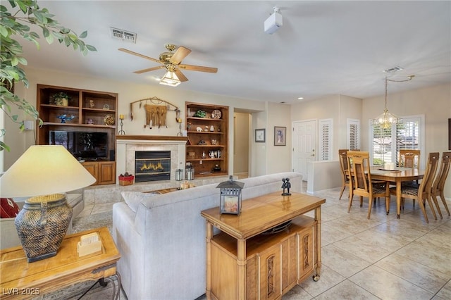 1620 Fieldbrook St, Henderson, NV 89052 - living area with ceiling fan, light tile patterned floors, and a tile fireplace