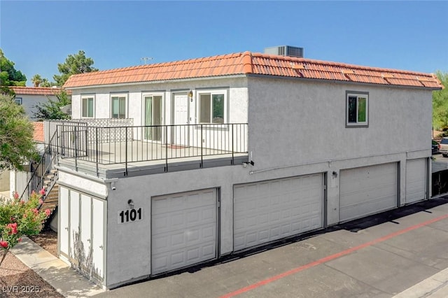 1101 Willow Tree Dr Unit D, Las Vegas, NV 89128 - rear view of property featuring a tiled roof, a garage, and stucco siding