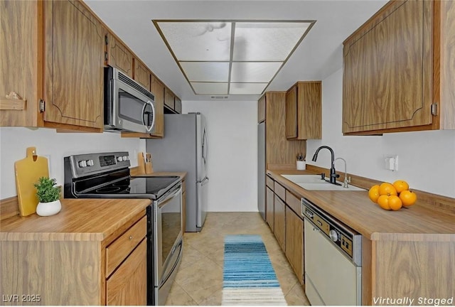 1101 Willow Tree Dr Unit D, Las Vegas, NV 89128 - kitchen featuring appliances with stainless steel finishes, light countertops, and light tile patterned flooring