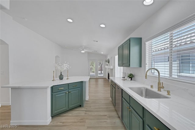 4369 Meadowlark Wing Way N, Las Vegas, NV 89084 - kitchen with green cabinets, a sink, a ceiling fan, light wood-style flooring, and a kitchen island