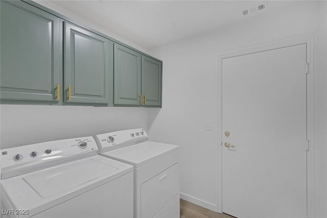 4369 Meadowlark Wing Way N, Las Vegas, NV 89084 - laundry room featuring cabinet space, washer and dryer, and light wood-style flooring