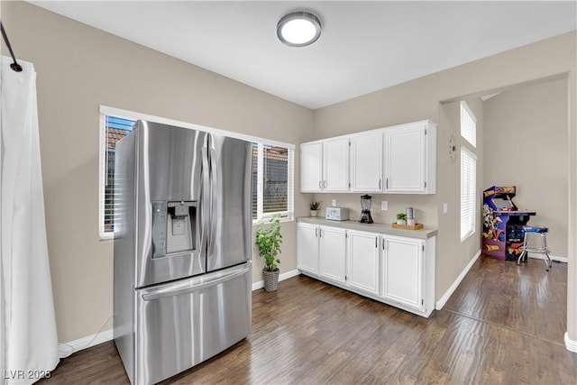 3659 Gerri Bay Ln, Las Vegas, NV 89147 - kitchen featuring stainless steel refrigerator with ice dispenser, plenty of natural light, light countertops, and baseboards