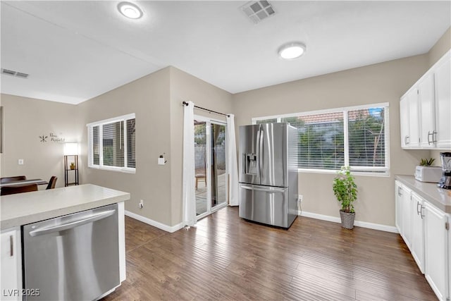 3659 Gerri Bay Ln, Las Vegas, NV 89147 - kitchen with appliances with stainless steel finishes, light countertops, baseboards, and white cabinetry
