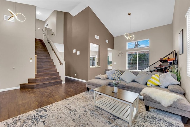 3659 Gerri Bay Ln, Las Vegas, NV 89147 - living area with high vaulted ceiling, wood finished floors, baseboards, stairway, and a chandelier